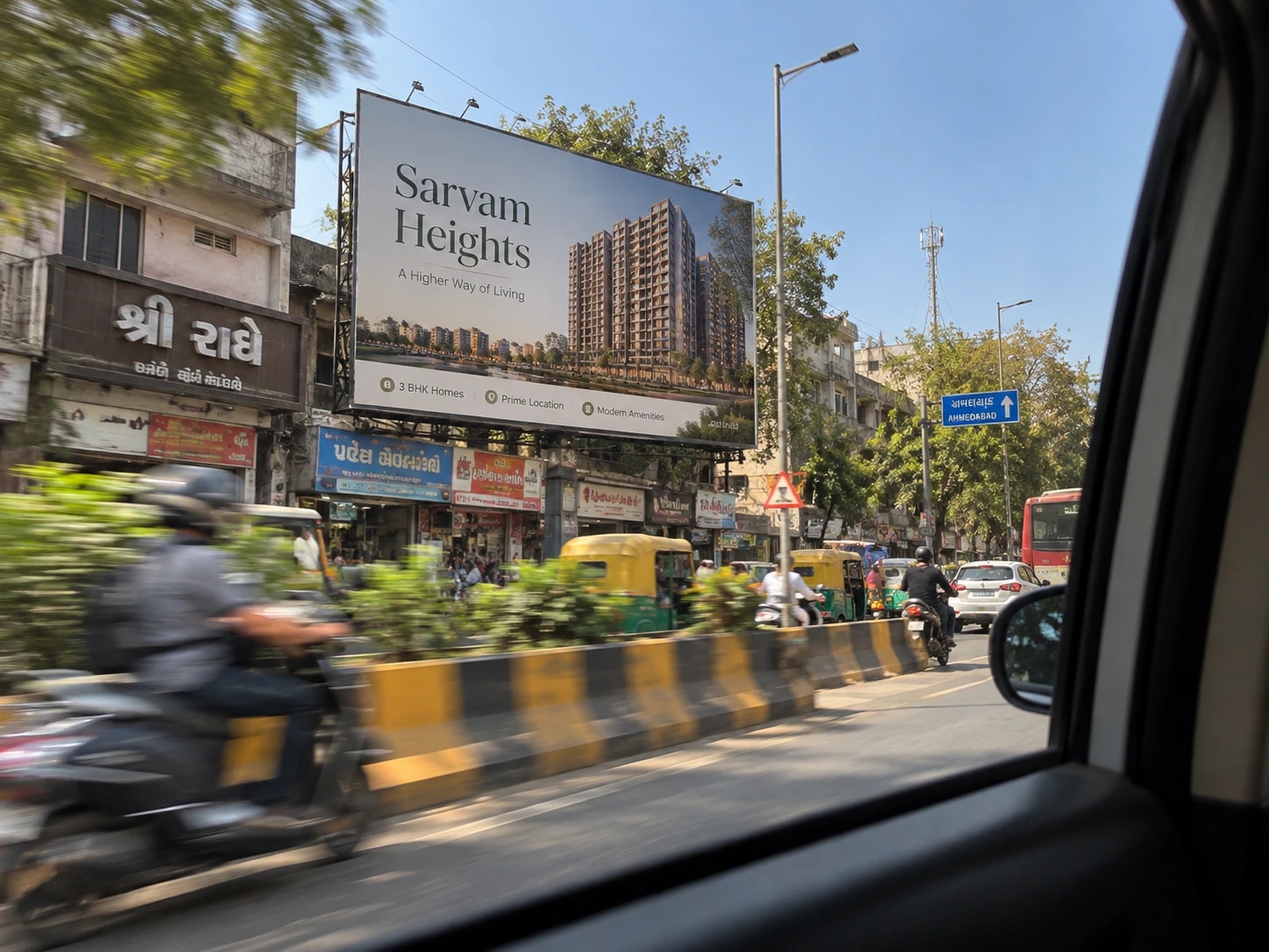A hoarding beside a busy road, with traffic passing it.